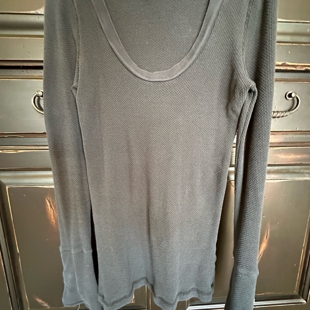 Free People black waffle top with super cute decorative sleeves. Size L